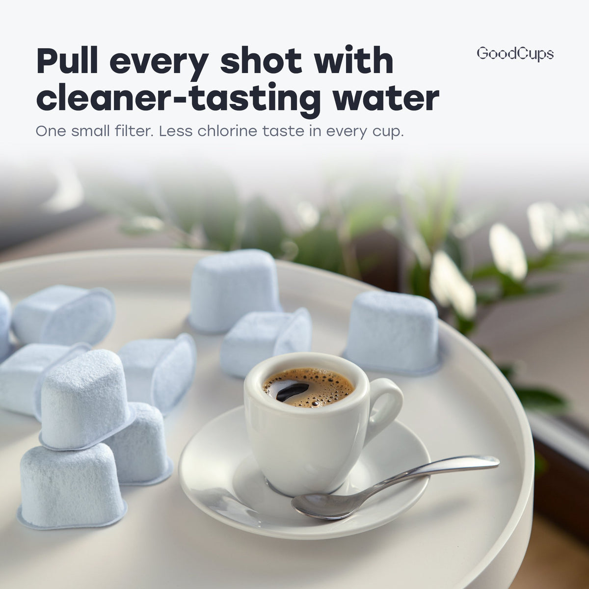 Espresso cup on a saucer surrounded by GoodCups charcoal water filters for Breville machines