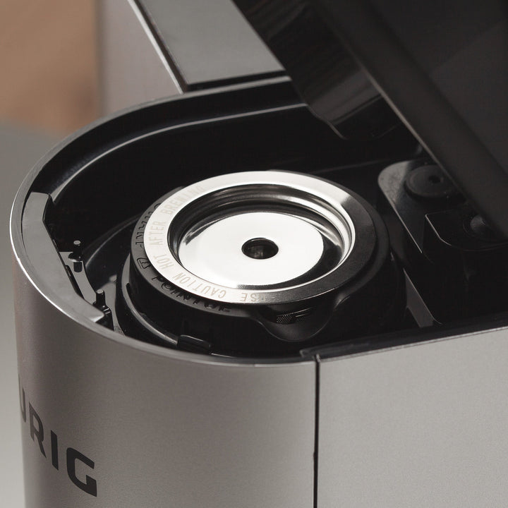 GoodCups stainless steel reusable K-Cup seated inside the brewing chamber of a Keurig coffee maker with the lid open