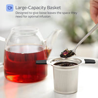 Tea infuser with loose tea leaves next to a teacup of red tea, with text about large-capacity basket.