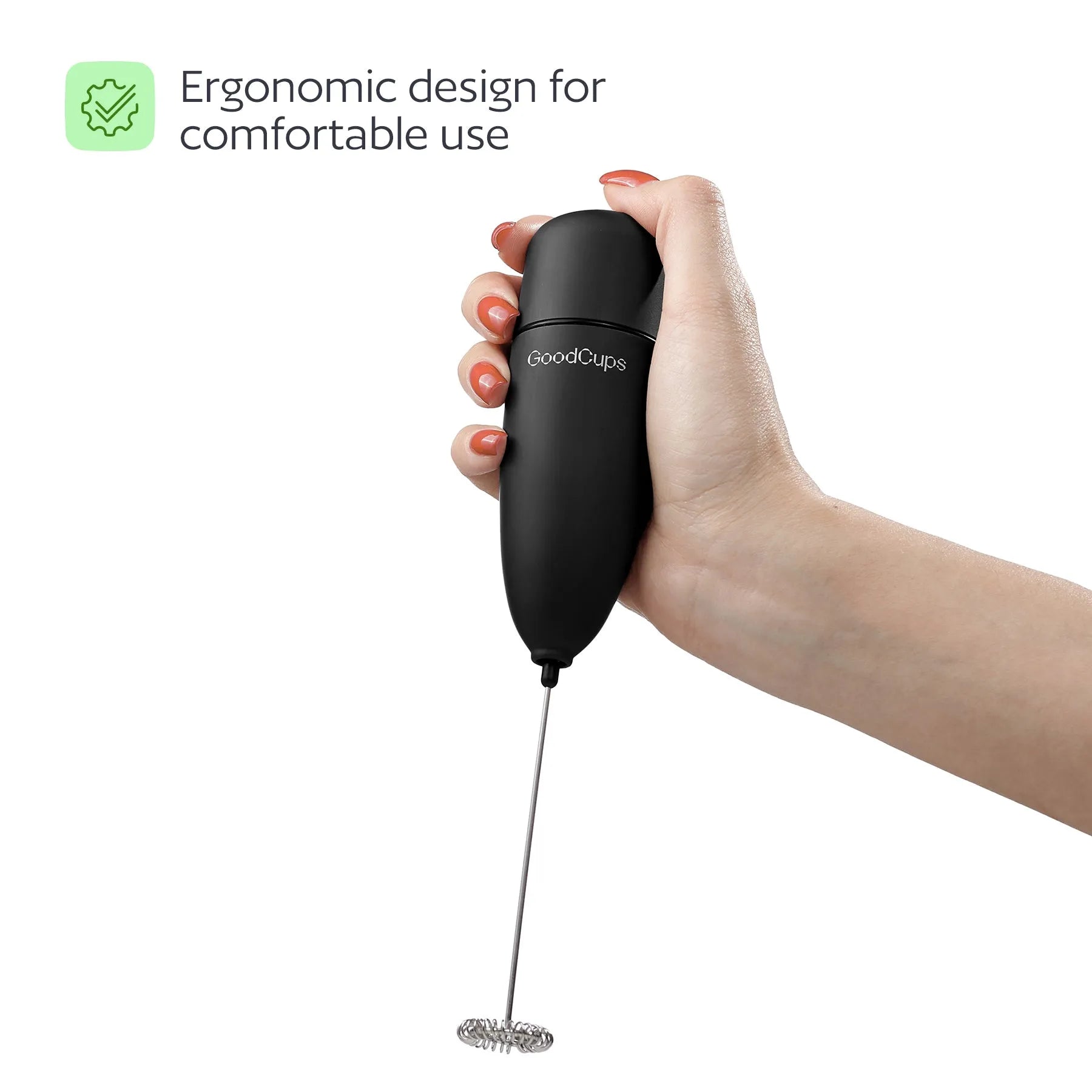 Hand holding a black GoodCups milk frother with text about ergonomic design on a white background